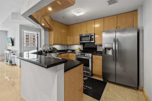 801 Brickell Key Blvd Unit 2006, Miami, FL 33131 - kitchen with appliances with stainless steel finishes, a peninsula, dark stone counters, and light tile patterned floors