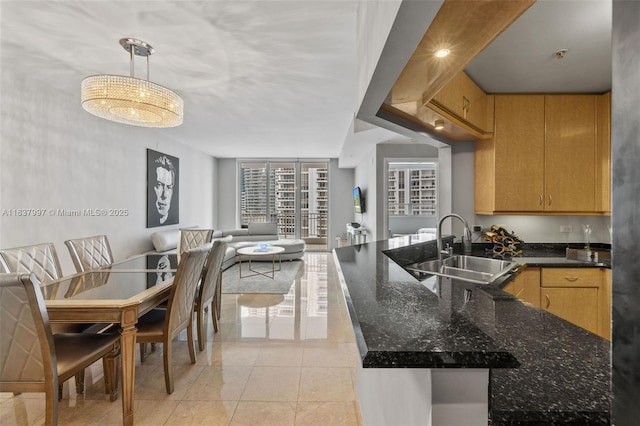 801 Brickell Key Blvd Unit 2006, Miami, FL 33131 - kitchen featuring open floor plan, pendant lighting, dark stone counters, light tile patterned floors, and a peninsula