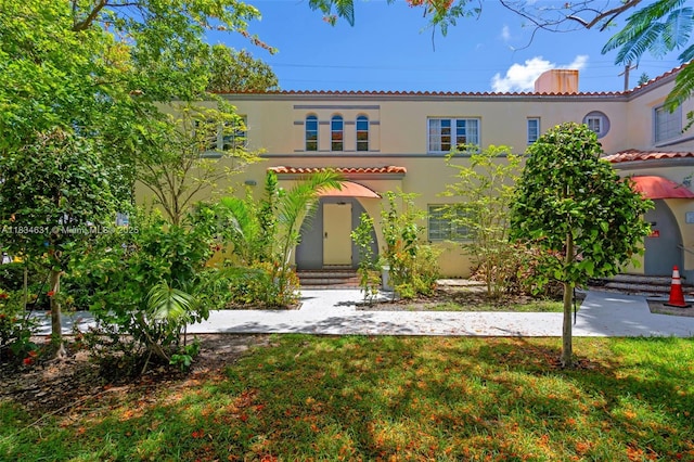 1450 Meridian Ave Unit 202, Miami Beach, FL 33139 - mediterranean / spanish home with stucco siding, entry steps, a chimney, and a front yard