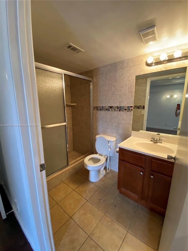 7640 Westwood Dr Unit 406, Tamarac, FL 33321 - full bathroom featuring tile patterned flooring, tile walls, vanity, and a shower stall
