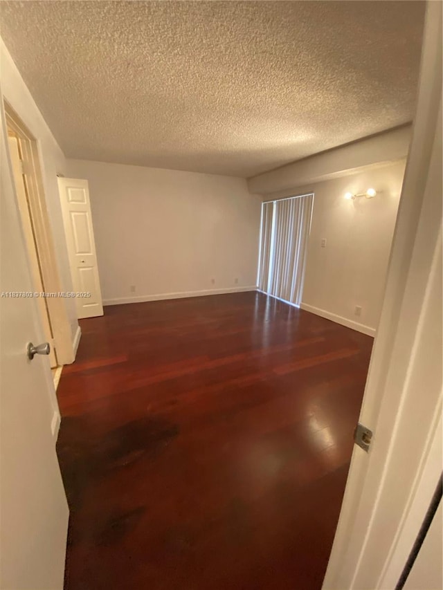 7640 Westwood Dr Unit 406, Tamarac, FL 33321 - unfurnished room with a textured ceiling and dark wood finished floors