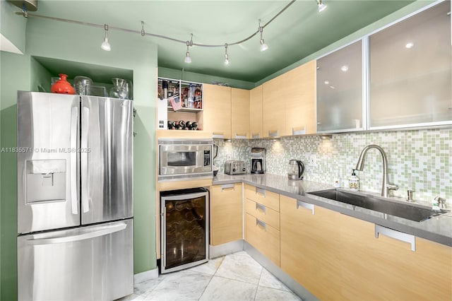 1623 Collins Ave Unit Ph1010, Miami Beach, FL 33139 - kitchen with appliances with stainless steel finishes, wine cooler, light brown cabinetry, and backsplash