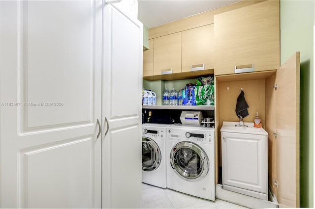 1623 Collins Ave Unit Ph1010, Miami Beach, FL 33139 - laundry area featuring washer and dryer, cabinet space, and light tile patterned floors