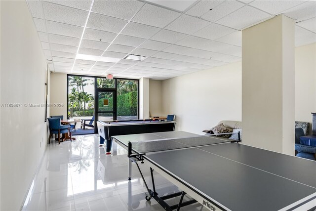 1623 Collins Ave Unit Ph1010, Miami Beach, FL 33139 - game room with a wall of windows, tile patterned flooring, and a paneled ceiling