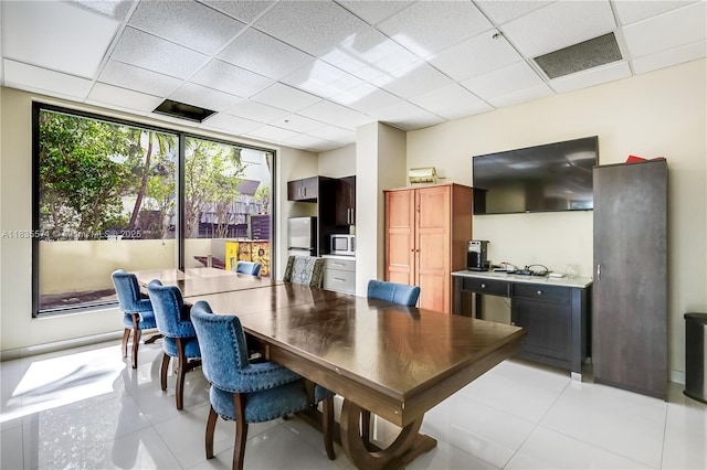 1623 Collins Ave Unit Ph1010, Miami Beach, FL 33139 - dining room featuring light tile patterned flooring and a paneled ceiling