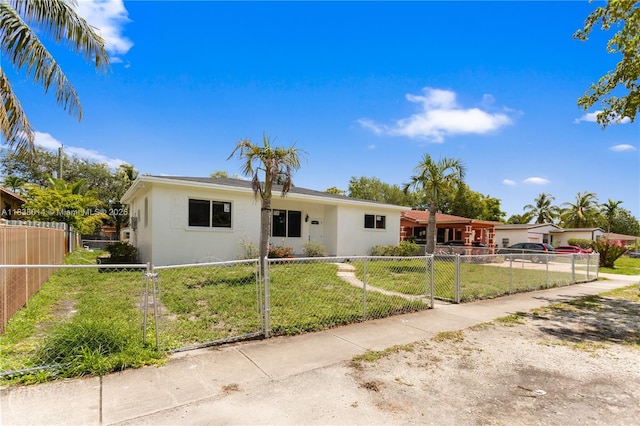775 NE 145th St, North Miami, FL 33161 - ranch-style house featuring stucco siding and a fenced front yard