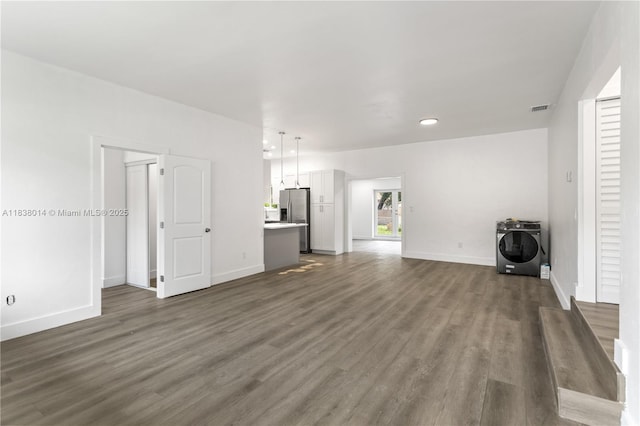 775 NE 145th St, North Miami, FL 33161 - unfurnished living room featuring washer / dryer, dark wood-style flooring, and recessed lighting