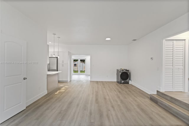 775 NE 145th St, North Miami, FL 33161 - unfurnished living room featuring light wood-style flooring and recessed lighting