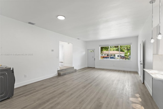 775 NE 145th St, North Miami, FL 33161 - unfurnished living room featuring light wood-style floors and washer / clothes dryer