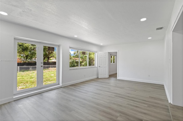 775 NE 145th St, North Miami, FL 33161 - spare room with recessed lighting, wood finished floors, and a textured ceiling