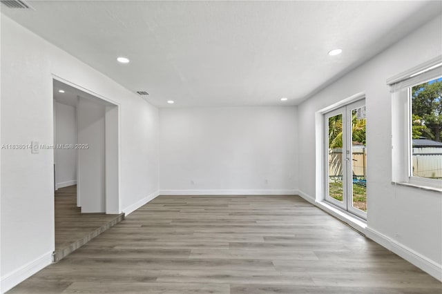775 NE 145th St, North Miami, FL 33161 - empty room with recessed lighting, wood finished floors, and french doors