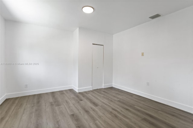 775 NE 145th St, North Miami, FL 33161 - unfurnished room featuring wood finished floors and baseboards