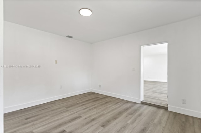 775 NE 145th St, North Miami, FL 33161 - unfurnished room with wood finished floors and baseboards