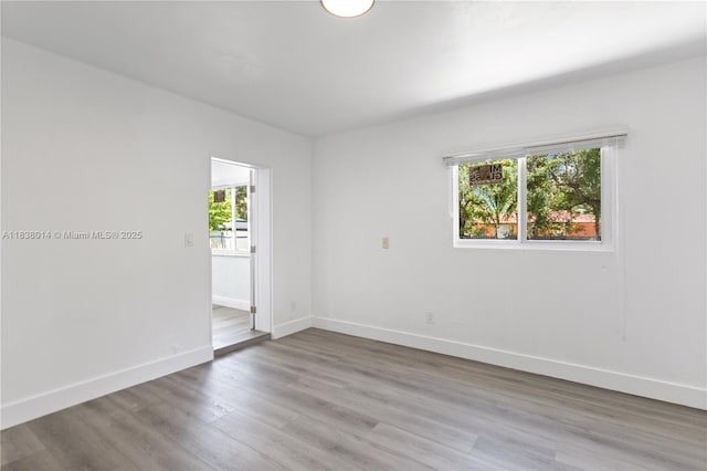 775 NE 145th St, North Miami, FL 33161 - unfurnished room with baseboards and wood finished floors