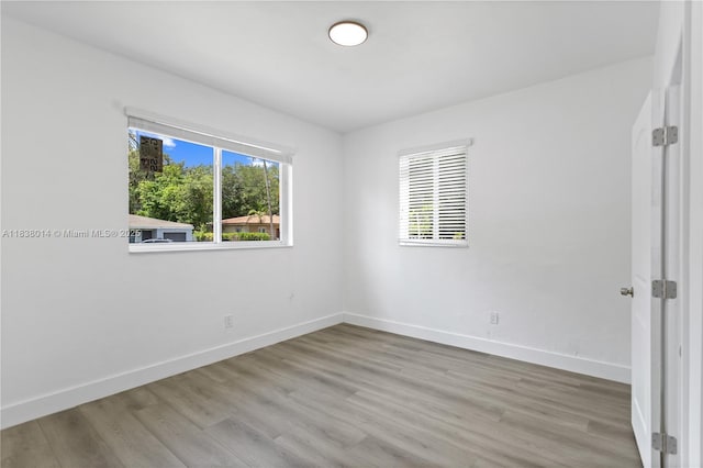 775 NE 145th St, North Miami, FL 33161 - empty room with baseboards and wood finished floors
