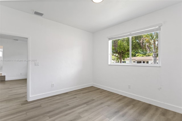 775 NE 145th St, North Miami, FL 33161 - unfurnished room featuring baseboards and light wood-style flooring