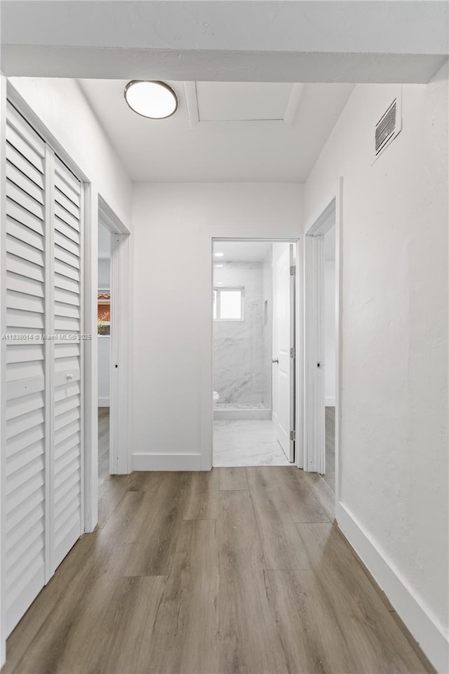 775 NE 145th St, North Miami, FL 33161 - hallway featuring wood finished floors and baseboards