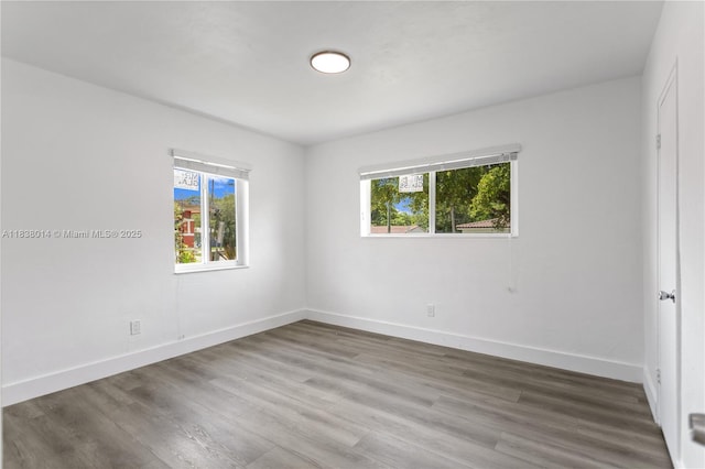 775 NE 145th St, North Miami, FL 33161 - spare room featuring wood finished floors and baseboards