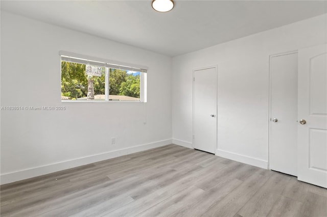 775 NE 145th St, North Miami, FL 33161 - unfurnished bedroom featuring light wood finished floors and baseboards