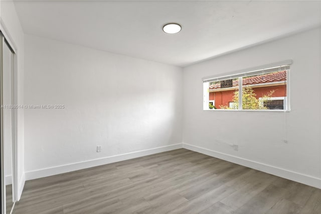 775 NE 145th St, North Miami, FL 33161 - unfurnished bedroom featuring wood finished floors and a closet
