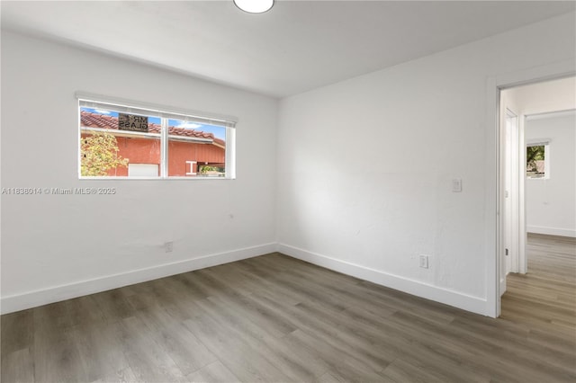 775 NE 145th St, North Miami, FL 33161 - spare room featuring wood finished floors and healthy amount of natural light