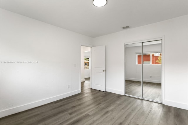 775 NE 145th St, North Miami, FL 33161 - unfurnished bedroom with wood finished floors and a closet