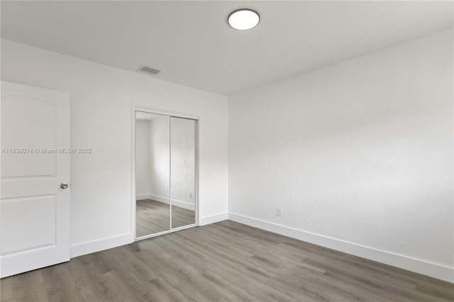 775 NE 145th St, North Miami, FL 33161 - unfurnished bedroom featuring wood finished floors and a closet