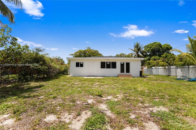 775 NE 145th St, North Miami, FL 33161 - back of property with entry steps and stucco siding