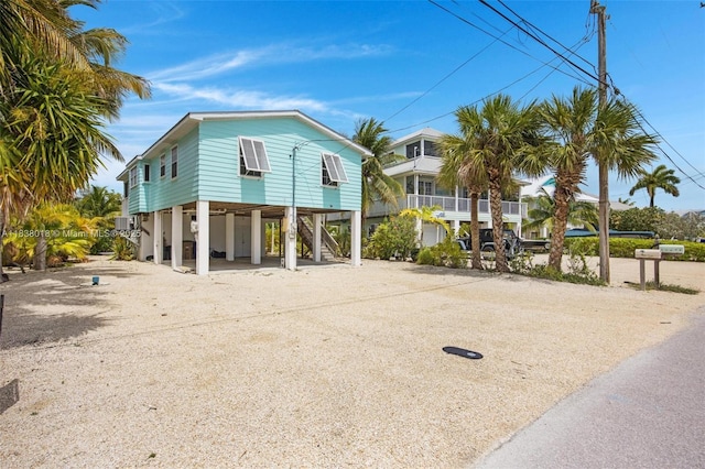547 Heck, Little Torch Key, FL 33042 - view of front facade featuring a carport, dirt driveway, and stairway