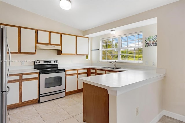 547 Heck, Little Torch Key, FL 33042 - kitchen featuring appliances with stainless steel finishes, under cabinet range hood, a peninsula, light countertops, and lofted ceiling