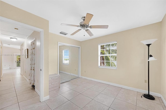 547 Heck, Little Torch Key, FL 33042 - unfurnished bedroom featuring light tile patterned floors, multiple windows, a closet, and ceiling fan