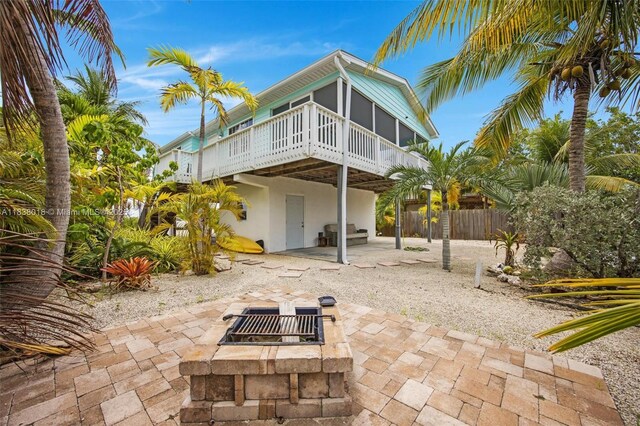 547 Heck, Little Torch Key, FL 33042 - rear view of house with a fire pit, a patio area, a deck, and stucco siding