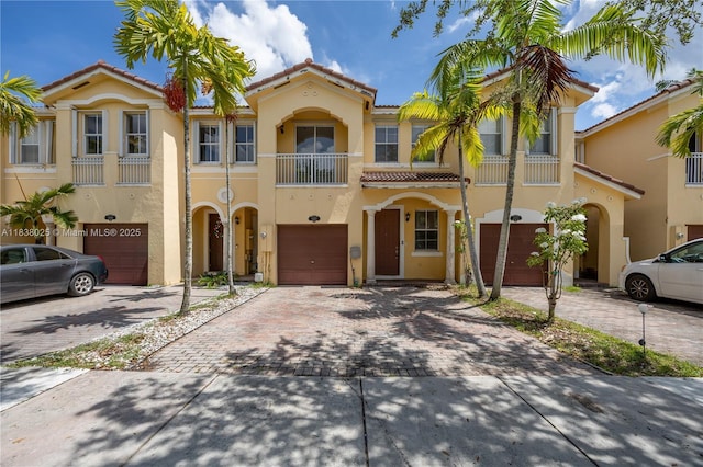 15057 SW 9th Ter, Miami, FL 33194 - view of front of home featuring an attached garage, a tiled roof, driveway, and stucco siding