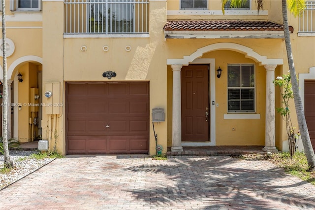 15057 SW 9th Ter, Miami, FL 33194 - property entrance with a garage, stucco siding, and a tiled roof