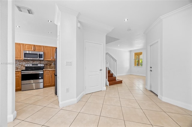 15057 SW 9th Ter, Miami, FL 33194 - kitchen with stainless steel appliances, light tile patterned floors, crown molding, decorative backsplash, and brown cabinets