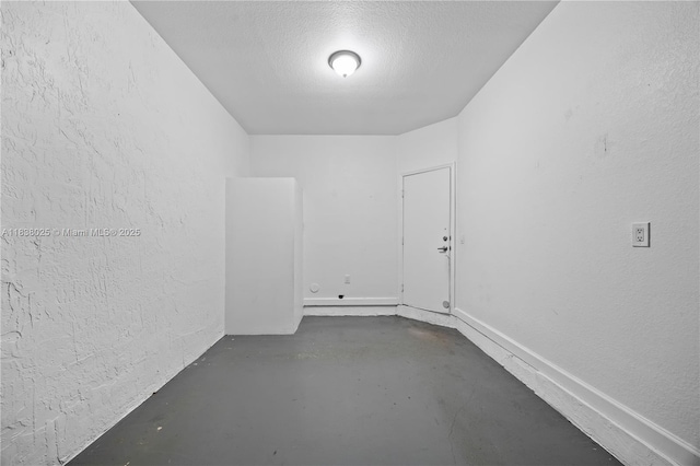 15057 SW 9th Ter, Miami, FL 33194 - empty room featuring finished concrete floors, a textured wall, and a textured ceiling