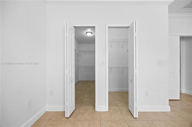 15057 SW 9th Ter, Miami, FL 33194 - unfurnished bedroom with light tile patterned flooring, a spacious closet, and crown molding