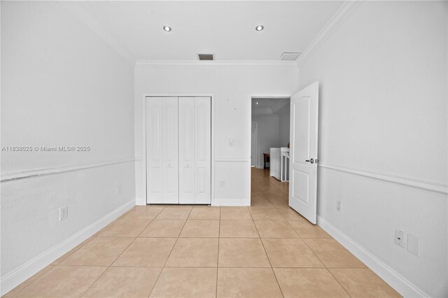 15057 SW 9th Ter, Miami, FL 33194 - unfurnished bedroom featuring crown molding, light tile patterned flooring, and a closet