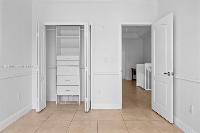 15057 SW 9th Ter, Miami, FL 33194 - unfurnished bedroom featuring light tile patterned floors, a closet, and crown molding