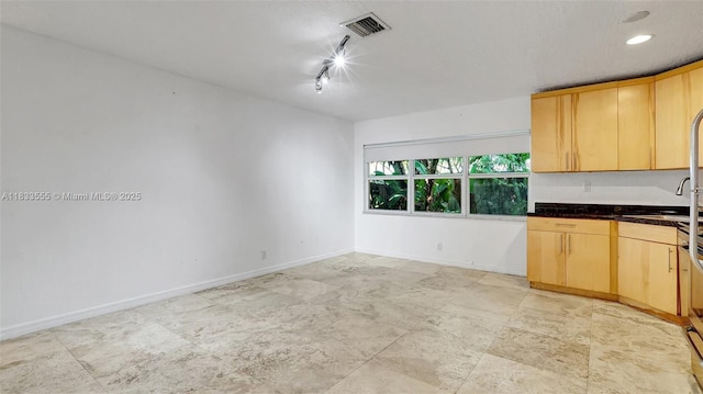1348 Holly Heights Dr Unit 17, Fort Lauderdale, FL 33304 - kitchen with light brown cabinetry, track lighting, and dark countertops