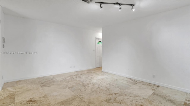 1348 Holly Heights Dr Unit 17, Fort Lauderdale, FL 33304 - spare room featuring baseboards and track lighting