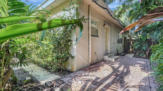 1348 Holly Heights Dr Unit 17, Fort Lauderdale, FL 33304 - view of property exterior with stucco siding and a patio
