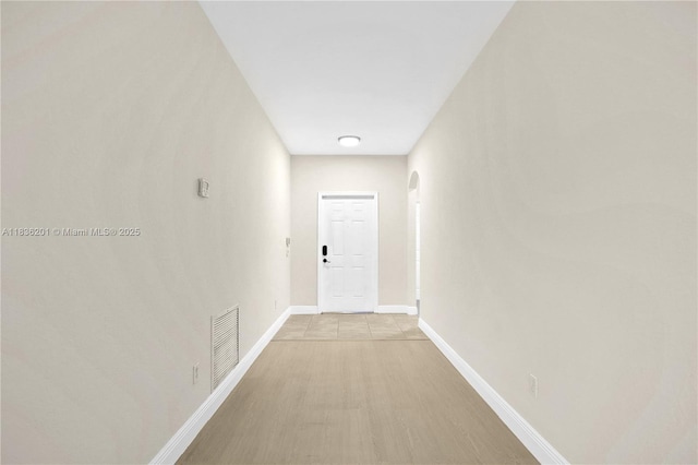 798 Quartz Ter, Palm Beach, FL 33413 - corridor with arched walkways and light wood-style floors