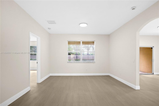 798 Quartz Ter, Palm Beach, FL 33413 - spare room with wood finished floors and arched walkways