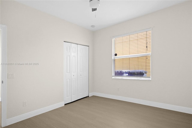 798 Quartz Ter, Palm Beach, FL 33413 - unfurnished bedroom featuring wood finished floors, a closet, and a ceiling fan
