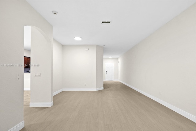 798 Quartz Ter, Palm Beach, FL 33413 - spare room with light wood-style flooring, a smoke detector, and arched walkways