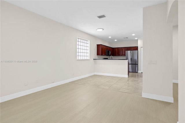 798 Quartz Ter, Palm Beach, FL 33413 - unfurnished living room with light wood-style flooring and recessed lighting