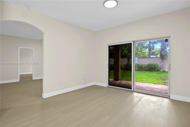 798 Quartz Ter, Palm Beach, FL 33413 - empty room featuring wood finished floors and arched walkways