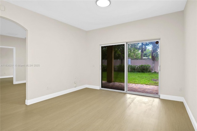 798 Quartz Ter, Palm Beach, FL 33413 - empty room featuring wood finished floors and arched walkways
