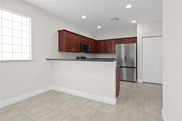 798 Quartz Ter, Palm Beach, FL 33413 - kitchen with stainless steel appliances, light tile patterned floors, recessed lighting, a peninsula, and dark countertops